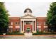 Brick Snellville City Hall with a clock tower and columns at 4351 Portsbrook Ave, Snellville, GA 30039