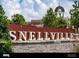 Large Snellville sign with brick wall and clock tower backdrop at 4351 Portsbrook Ave, Snellville, GA 30039