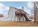 Rear view of house showing a two story deck, white fence, hot tub, garage access and wooded area at 612 Cole Creek Dr, Dallas, GA 30157