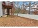 A spacious backyard with a white fence, grass, and a deck overlooking the yard at 612 Cole Creek Dr, Dallas, GA 30157