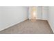 Blank bedroom with medium toned carpet, white walls, and two entry doors at 612 Cole Creek Dr, Dallas, GA 30157