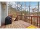 Rustic outdoor deck with a grill and views of the surrounding woods at 612 Cole Creek Dr, Dallas, GA 30157