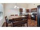 Cozy dining area with seating for six adjacent to the kitchen with wooden floor at 612 Cole Creek Dr, Dallas, GA 30157