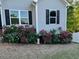 Charming home exterior with roses and flower beds, with a lush green lawn at 612 Cole Creek Dr, Dallas, GA 30157