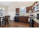 Cozy kitchen with wood floors, granite counters, and modern appliances, adjacent to dining area at 612 Cole Creek Dr, Dallas, GA 30157