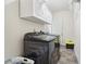 Convenient laundry room with overhead storage and a modern washer and dryer set at 612 Cole Creek Dr, Dallas, GA 30157