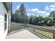 Wooden back deck offering a view of the backyard and surrounding trees under a clear blue sky at 275 Creek View Ln, Acworth, GA 30102