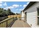 Wooden back deck attached to a white two-story home overlooks a spacious green backyard at 275 Creek View Ln, Acworth, GA 30102