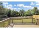 Wooden back deck with a railing overlooking a spacious green backyard and blue skies at 275 Creek View Ln, Acworth, GA 30102