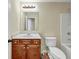 Bright bathroom featuring a vanity with wooden cabinets and a standard toilet and shower at 275 Creek View Ln, Acworth, GA 30102