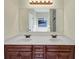 Bathroom vanity with dual sinks, updated lighting, and mirror at 275 Creek View Ln, Acworth, GA 30102