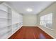 Bedroom with hardwood floors, neutral walls, built-in shelving, and a bright window at 275 Creek View Ln, Acworth, GA 30102