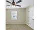 Bedroom with neutral walls, ceiling fan, and window at 275 Creek View Ln, Acworth, GA 30102