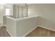 Upstairs hallway with neutral walls, carpeted floor, and a decorative hanging light at 275 Creek View Ln, Acworth, GA 30102