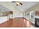 Open-concept living room with hardwood floors, a fireplace, and a view into the adjacent kitchen at 275 Creek View Ln, Acworth, GA 30102