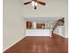 Open living room featuring hardwood floors, a ceiling fan, and an open view into the kitchen at 275 Creek View Ln, Acworth, GA 30102