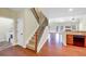 Open-concept living room view from the stairs featuring hardwood floors, neutral walls and fireplace at 275 Creek View Ln, Acworth, GA 30102