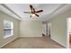 Carpeted main bedroom featuring natural lighting and a ceiling fan at 275 Creek View Ln, Acworth, GA 30102