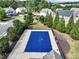 View of the community pool covered by a blue tarp and surrounded by a black fence and trees at 275 Creek View Ln, Acworth, GA 30102