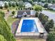 View of the community pool covered by a blue tarp, clubhouse, and surrounding trees at 275 Creek View Ln, Acworth, GA 30102