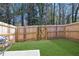 A fenced backyard features lush green grass, a table, and privacy at 4191 Spring Valley Cir, Tucker, GA 30084