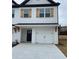 Beautiful townhome featuring painted brick, dark accents, and an attached two car garage at 4191 Spring Valley Cir, Tucker, GA 30084