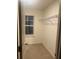 Organized walk-in closet featuring carpeted floors and a sturdy metal rack for optimal storage at 4191 Spring Valley Cir, Tucker, GA 30084