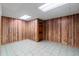 Unfinished basement with wood paneling and tile floors at 561 Congress Pkwy, Lawrenceville, GA 30044