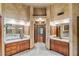 Double vanity bathroom with granite countertops and wood cabinets at 561 Congress Pkwy, Lawrenceville, GA 30044