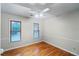 Well-lit bedroom with hardwood floors and wainscoting at 561 Congress Pkwy, Lawrenceville, GA 30044