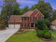 Brick two-story house with a two-car garage and landscaped yard at 561 Congress Pkwy, Lawrenceville, GA 30044