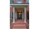 Elegant front entrance with a black door, brick steps, and columned portico at 561 Congress Pkwy, Lawrenceville, GA 30044