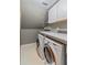 Laundry room with washer, dryer, and built-in cabinets at 561 Congress Pkwy, Lawrenceville, GA 30044