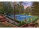 Two well-lit tennis courts nestled in a wooded area at 561 Congress Pkwy, Lawrenceville, GA 30044