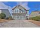 Charming two-story home with light-blue siding, decorative trim, and a two-car garage at 1510 Lily Valley Dr, Lawrenceville, GA 30045