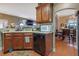 The kitchen area features wood cabinets, a dishwasher, and a view into the dining room at 1510 Lily Valley Dr, Lawrenceville, GA 30045