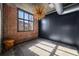 Bedroom with brick accent wall, dark paint, and a modern light fixture at 640 Glen Iris Ne Dr # 515, Atlanta, GA 30308