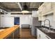 Modern kitchen featuring stainless steel appliances, a kitchen island, and industrial style lighting and exposed ductwork at 640 Glen Iris Ne Dr # 515, Atlanta, GA 30308