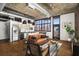 Open-concept living area featuring hardwood floors, exposed ductwork, and large windows offering city views at 640 Glen Iris Ne Dr # 515, Atlanta, GA 30308