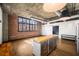 Living space with exposed ductwork, brick accent wall and hardwood floors at 640 Glen Iris Ne Dr # 515, Atlanta, GA 30308