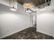 Open living room with concrete floors, exposed ceiling, and modern lighting fixtures at 640 Glen Iris Ne Dr # 515, Atlanta, GA 30308