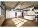 Spacious living area with exposed ductwork, hardwood floors, and sliding barn door at 640 Glen Iris Ne Dr # 515, Atlanta, GA 30308