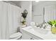 Clean bathroom with white vanity, shower, and toilet at 7483 Pleasant Hill Rd, Lithonia, GA 30058