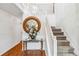 Bright entryway with hardwood floors, elegant mirror, and staircase at 7483 Pleasant Hill Rd, Lithonia, GA 30058