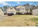 Two-story house with attached garage and landscaped lawn at 7483 Pleasant Hill Rd, Lithonia, GA 30058