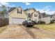 Two-story house with attached garage and driveway at 7483 Pleasant Hill Rd, Lithonia, GA 30058