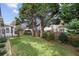 A fenced back yard has mature trees and a patio that is shaded by the house at 2224 Snug Ne Hbr, Marietta, GA 30066