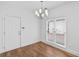 Dining area with hardwood floors, a modern chandelier, and large windows for natural light at 2224 Snug Ne Hbr, Marietta, GA 30066