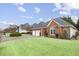 Charming brick home featuring a well-manicured lawn and attached two-car garage at 2224 Snug Ne Hbr, Marietta, GA 30066