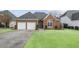 This brick home has a manicured front lawn, a two car garage and a covered front entry at 2224 Snug Ne Hbr, Marietta, GA 30066